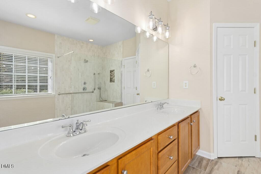 4800 Rhythm Drive Apex, NC 27539 - Photo 18 of 32 a bathroom with a sink double vanity and a mirror