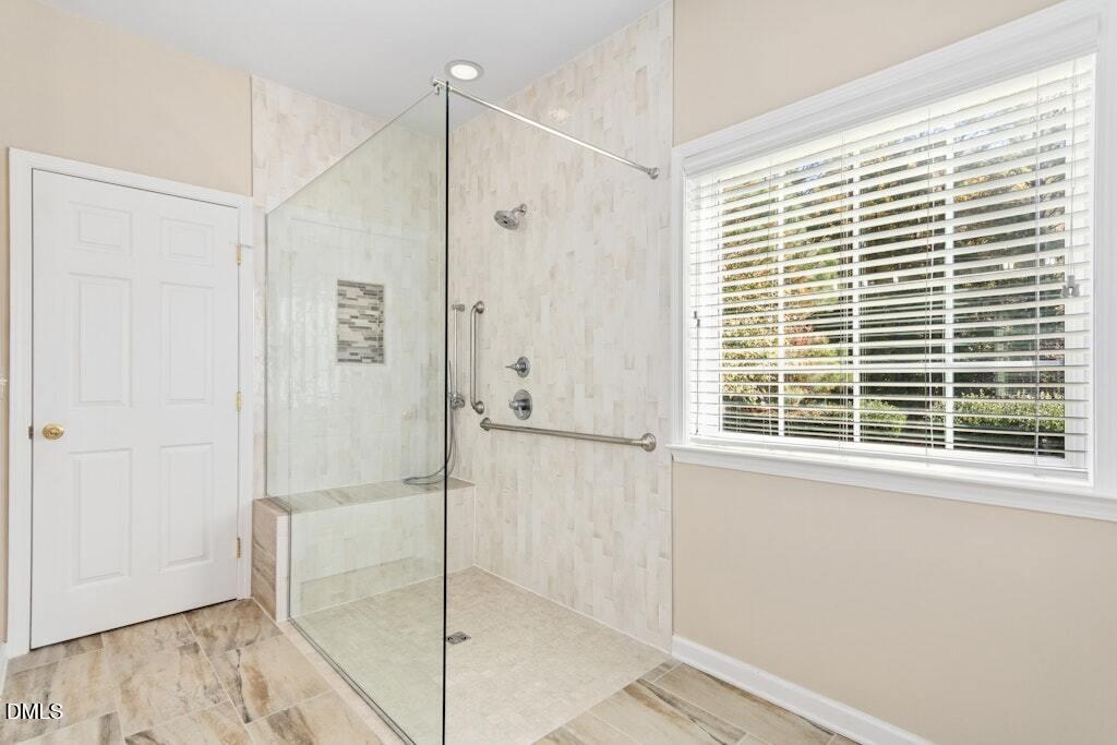 4800 Rhythm Drive Apex, NC 27539 - Photo 19 of 32 a bathroom with a shower and a glass door