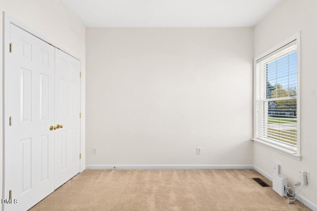 4800 Rhythm Drive Apex, NC 27539 - Photo 21 of 32 a view of an empty room with a window