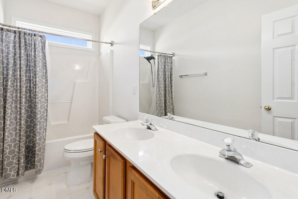 4800 Rhythm Drive Apex, NC 27539 - Photo 22 of 32 a bathroom with a sink and a mirror