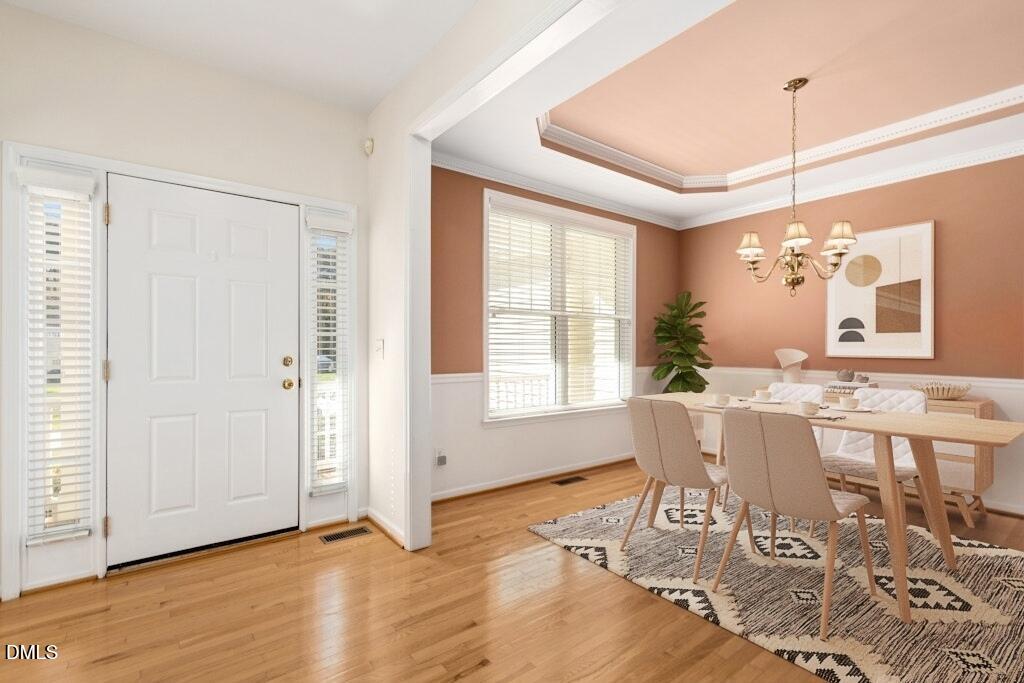 4800 Rhythm Drive Apex, NC 27539 - Photo 3 of 32 a view of a dining room with furniture window and wooden floor
