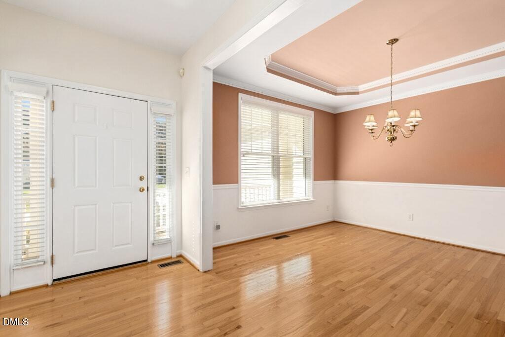 4800 Rhythm Drive Apex, NC 27539 - Photo 4 of 32 an empty room with wooden floor and windows