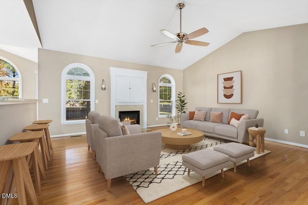 4800 Rhythm Drive Apex, NC 27539 - Photo 8 of 32 a living room with furniture a fireplace and a large window