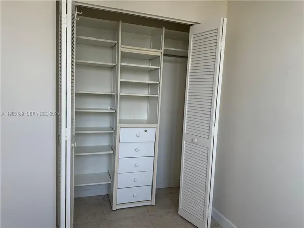 a bathroom with a granite countertop sink a toilet a mirror and bathtub