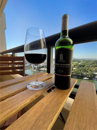 a living room with furniture and floor to ceiling windows