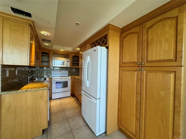a kitchen with stainless steel appliances granite countertop a sink and cabinets