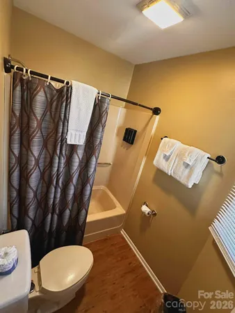 a bathroom with a sink mirror vanity and toilet