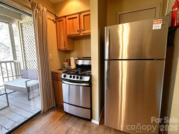 a white refrigerator freezer and a stove sitting inside of a kitchen