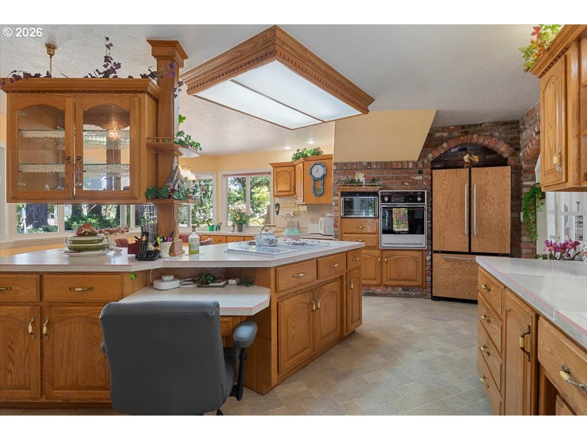 1300 Fair Oaks Road Oakland, OR 97462 - Photo 15 of 48 a kitchen with stainless steel appliances granite countertop a sink a stove and a refrigerator