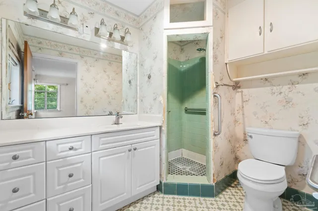 a bathroom with a sink a toilet and shower