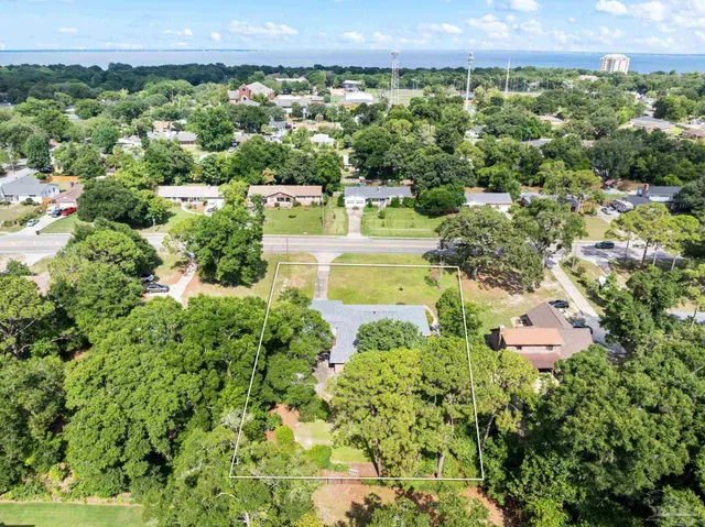 a view of a garden with a building in the background