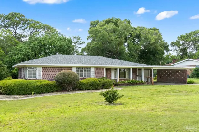 a front view of a house with a garden