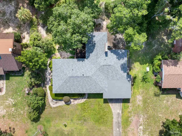 an aerial view of a residential houses with outdoor space and street view