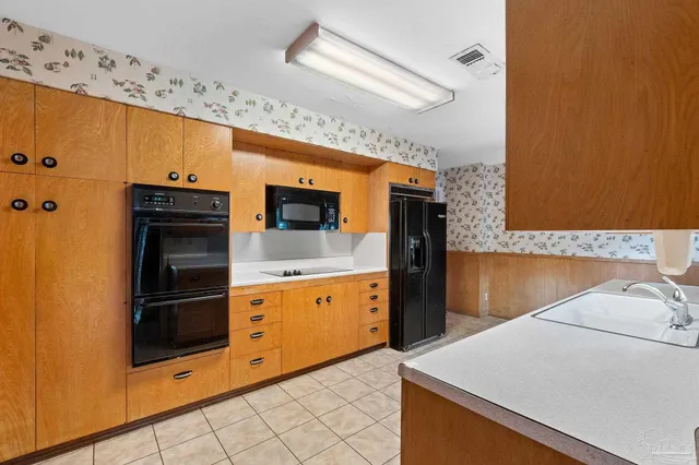 a kitchen with stainless steel appliances a stove microwave and refrigerator