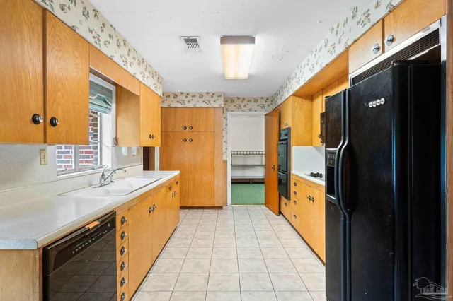 a bathroom with a granite countertop sink a mirror and shower