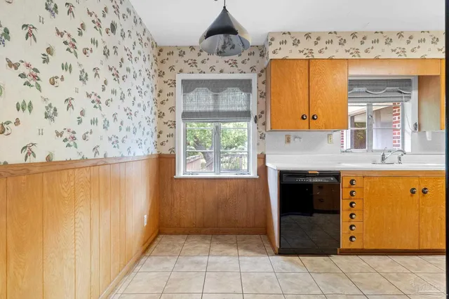 a view of kitchen with granite countertop cabinets and a fireplace