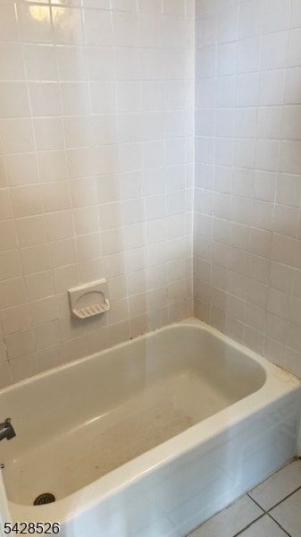 321 John Street Harrison, NJ 07029 - Photo 9 of 13 a bath tub sitting next to a white sink