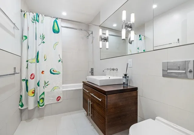 a kitchen with stainless steel appliances a dining table chairs stove and white cabinets