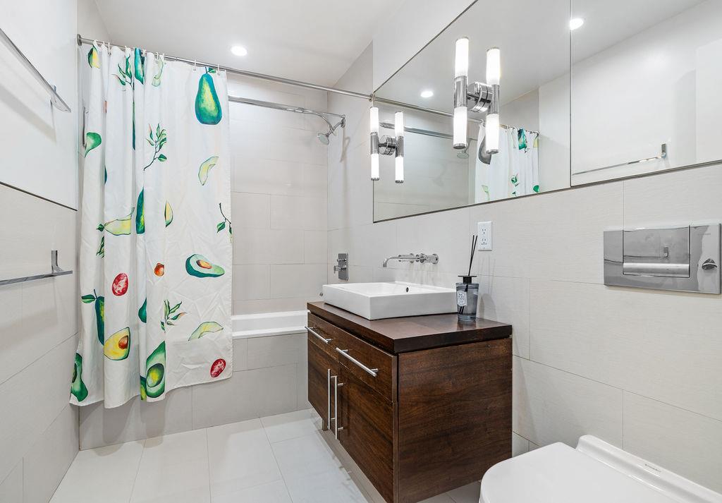 185 13th Street, Unit 3B Brooklyn, NY 11215 - Photo 5 of 8 a bathroom with a sink a vanity and a mirror