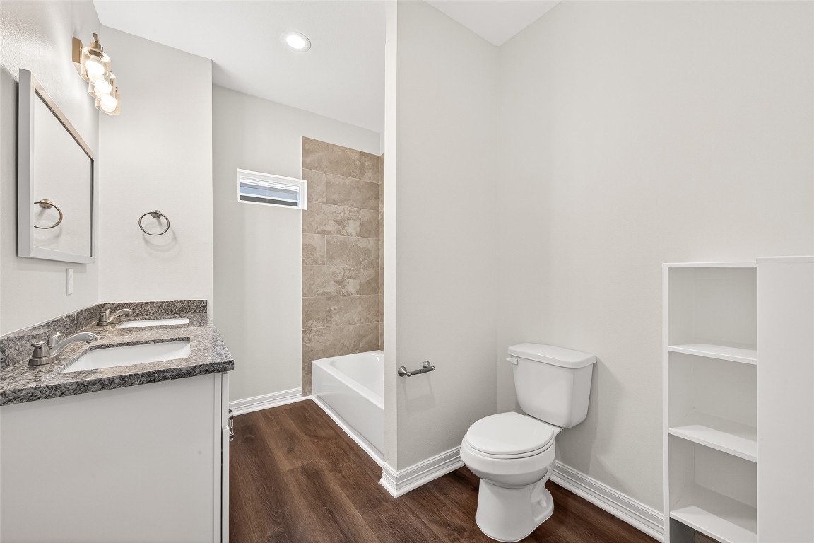418 North 4th Street Beasley, TX 77417 - Photo 16 of 27 a bathroom with a granite countertop toilet sink and a shower