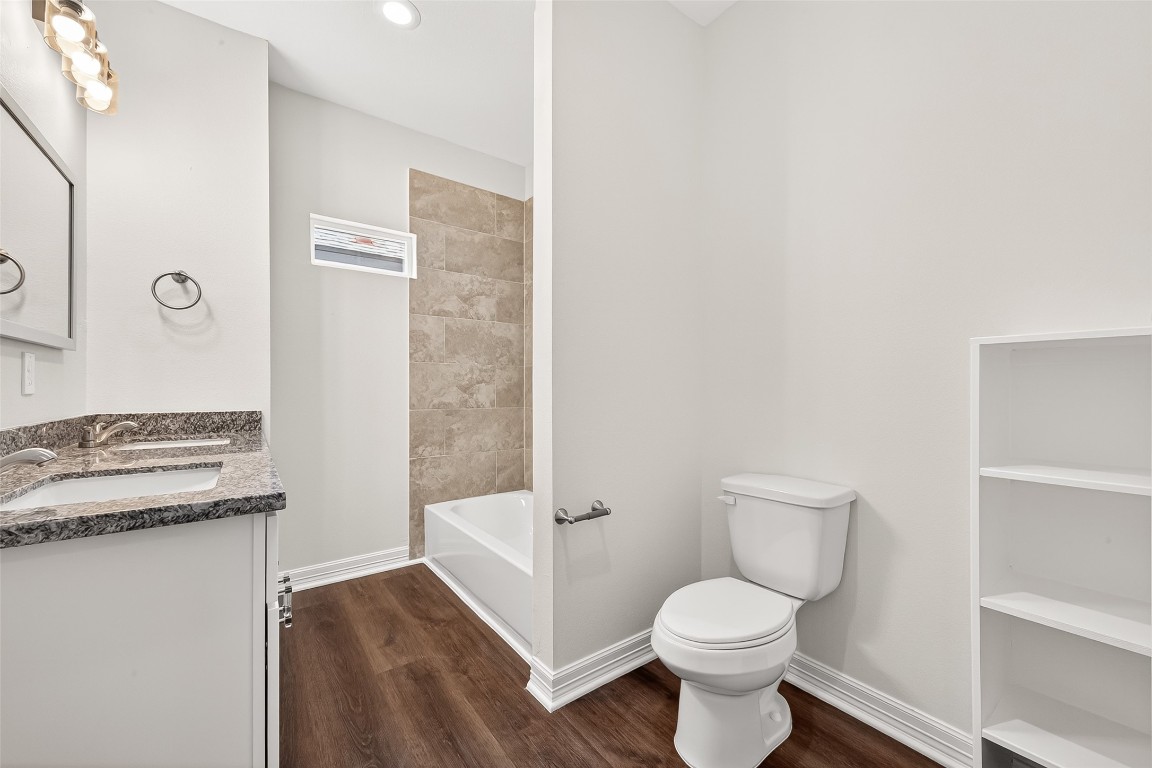 418 North 4th Street Beasley, TX 77417 - Photo 18 of 27 a white toilet sitting next to a bathroom sink
