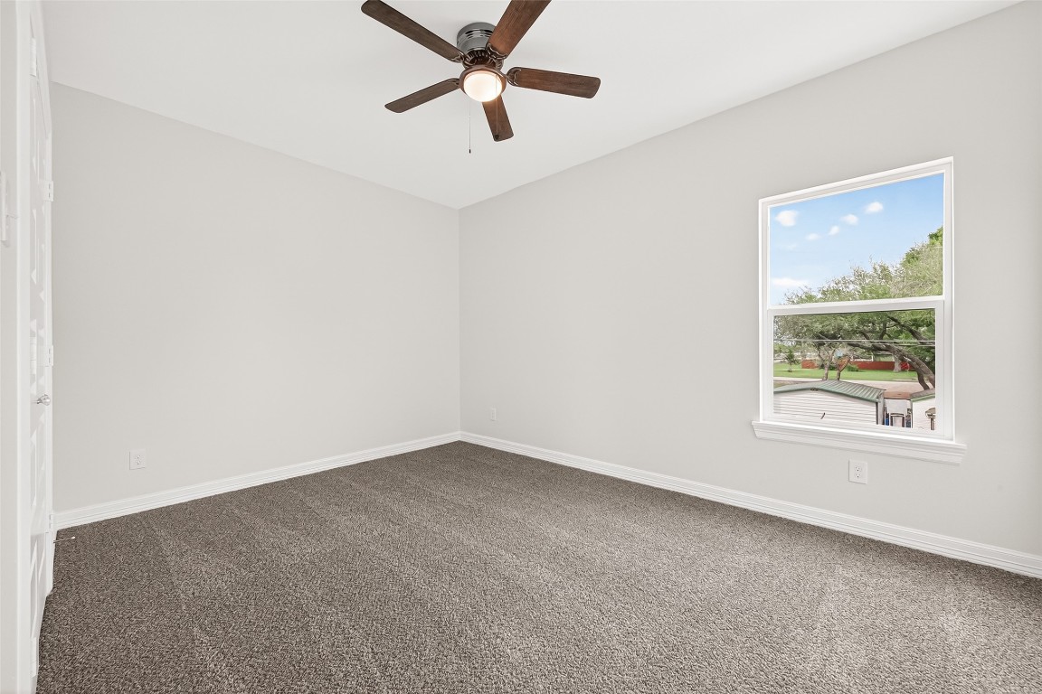 418 North 4th Street Beasley, TX 77417 - Photo 19 of 27 an empty room with a window and a fan