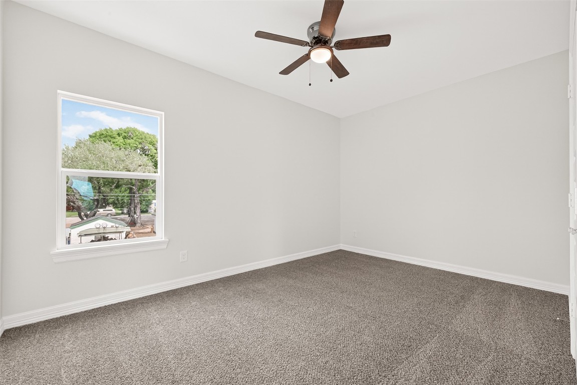 418 North 4th Street Beasley, TX 77417 - Photo 23 of 27 an empty room with a window and a fan