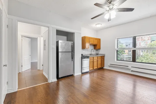 a view of kitchen with furniture and stainless steel appliances