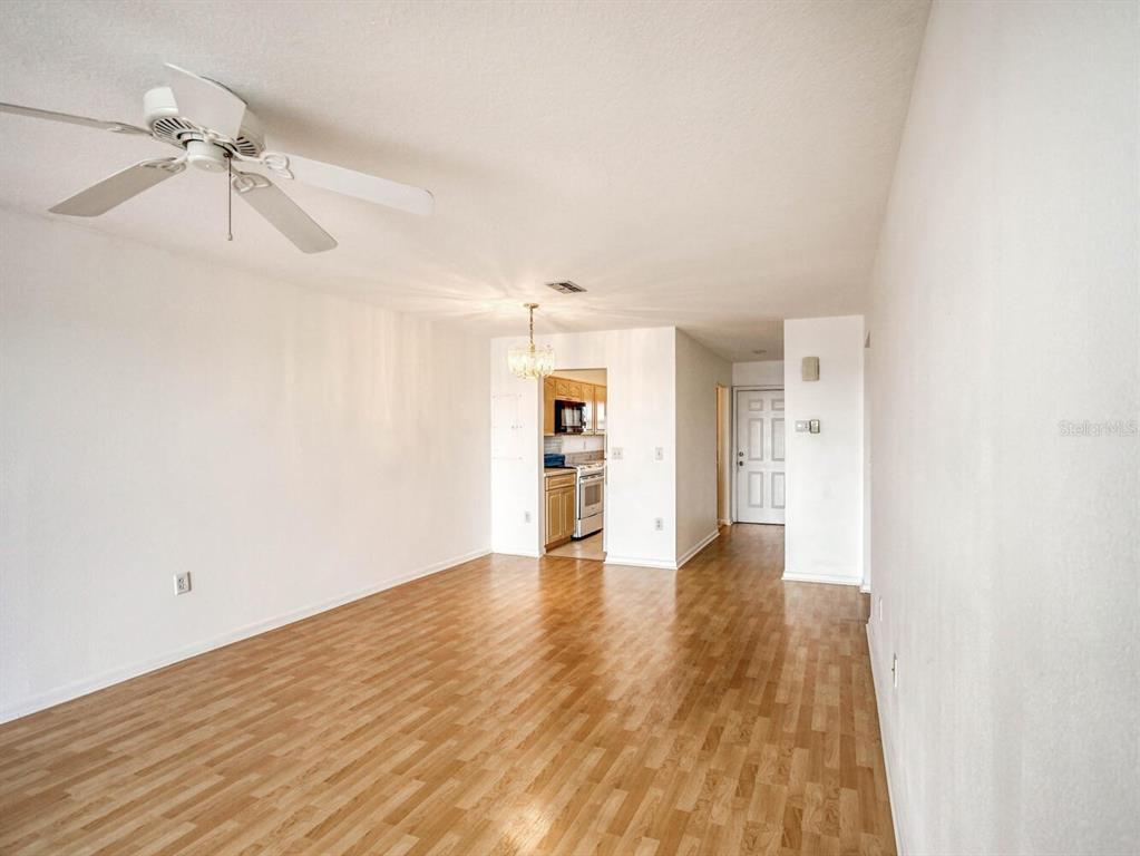 4939 Floramar Terrace, Unit 912 New Port Richey, FL 34652 - Photo 14 of 55 a view of an empty room with a window and wooden floor