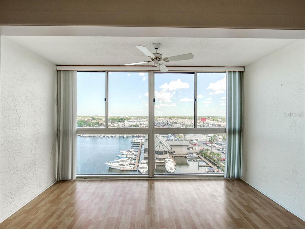 4939 Floramar Terrace, Unit 912 New Port Richey, FL 34652 - Photo 19 of 55 an empty room with wooden floor and windows