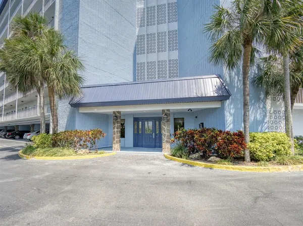 a front view of a house with lots of green space
