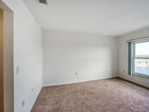 a view of wooden floor and windows in a room