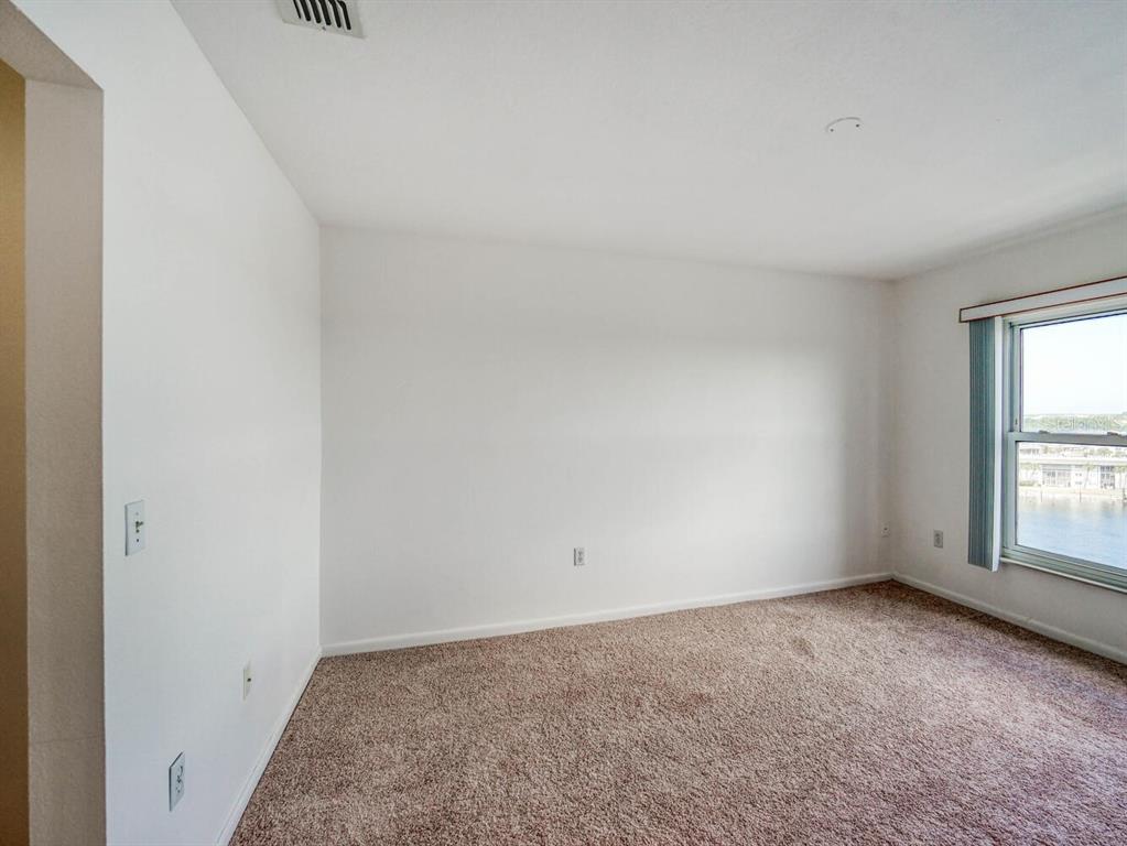 4939 Floramar Terrace, Unit 912 New Port Richey, FL 34652 - Photo 24 of 55 an empty room with windows