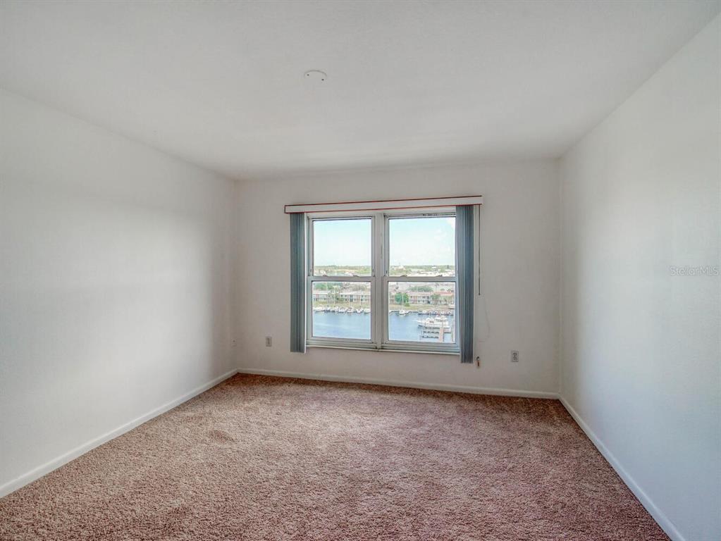 4939 Floramar Terrace, Unit 912 New Port Richey, FL 34652 - Photo 25 of 55 an empty room with a window