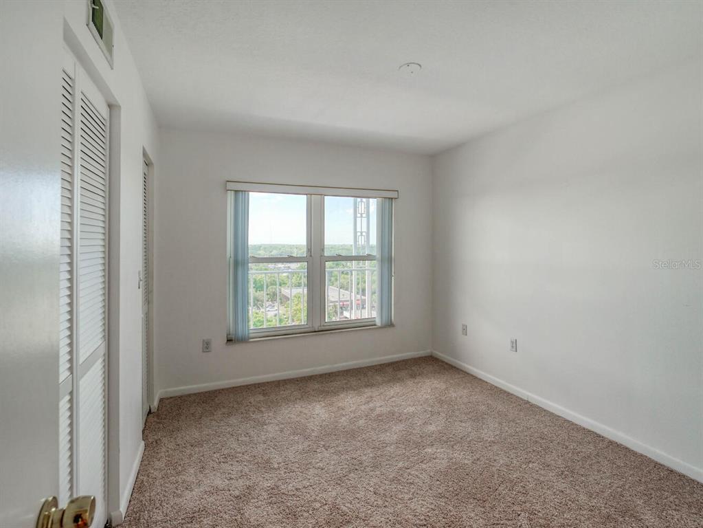 4939 Floramar Terrace, Unit 912 New Port Richey, FL 34652 - Photo 29 of 55 an empty room with a window