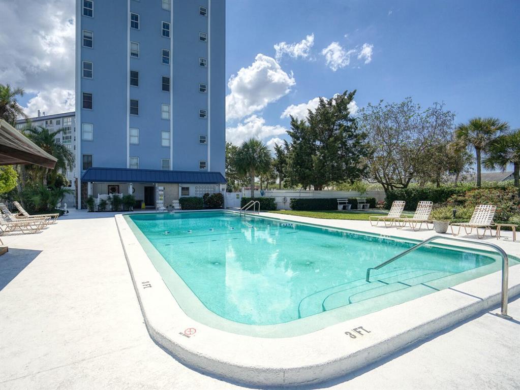 4939 Floramar Terrace, Unit 912 New Port Richey, FL 34652 - Photo 39 of 55 a view of a swimming pool with a sitting space