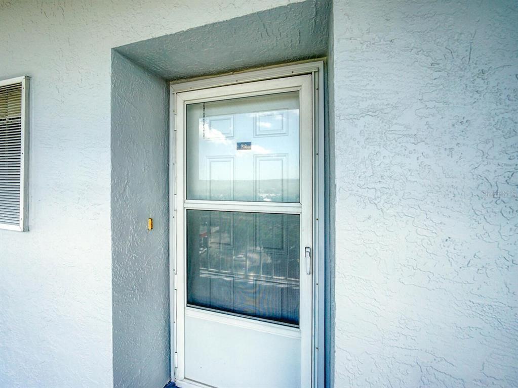 4939 Floramar Terrace, Unit 912 New Port Richey, FL 34652 - Photo 5 of 55 a view of a glass door of a house