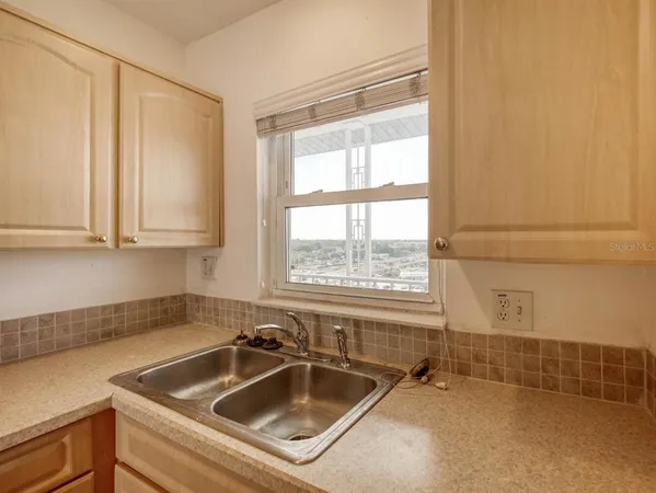 a kitchen with a sink and cabinets