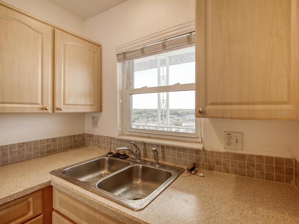 4939 Floramar Terrace, Unit 912 New Port Richey, FL 34652 - Photo 7 of 55 a kitchen with a sink and cabinets