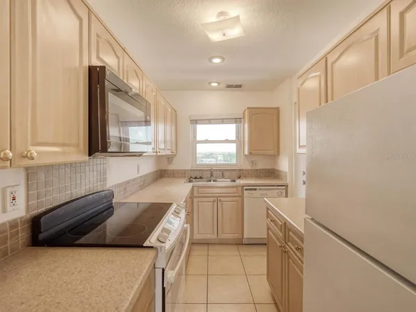 a kitchen with a stove a sink and a refrigerator