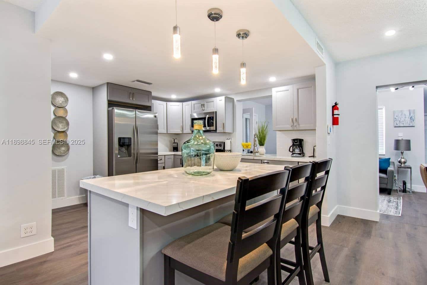 1305 Funston Street Hollywood, FL 33019 - Photo 2 of 93 a large kitchen with a table and chairs