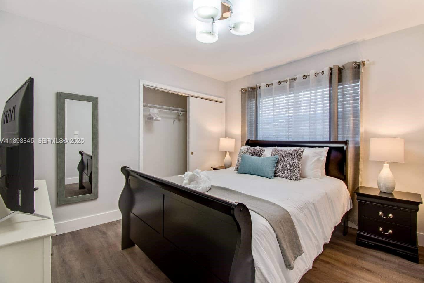 1305 Funston Street Hollywood, FL 33019 - Photo 27 of 93 a bedroom with a bed and wooden floor