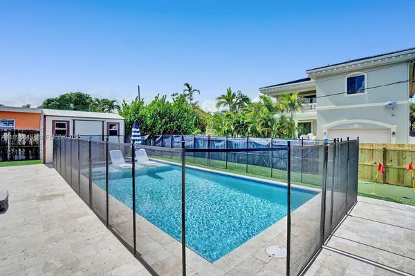 swimming pool view with a seating space
