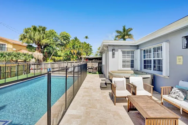 a view of a house with swimming pool and sitting area
