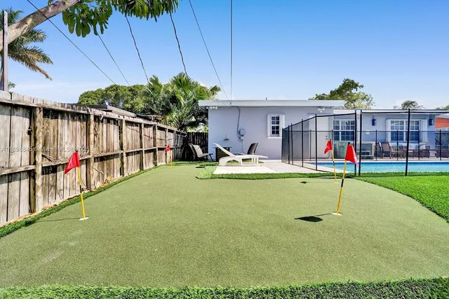 a view of a house with backyard porch and sitting area