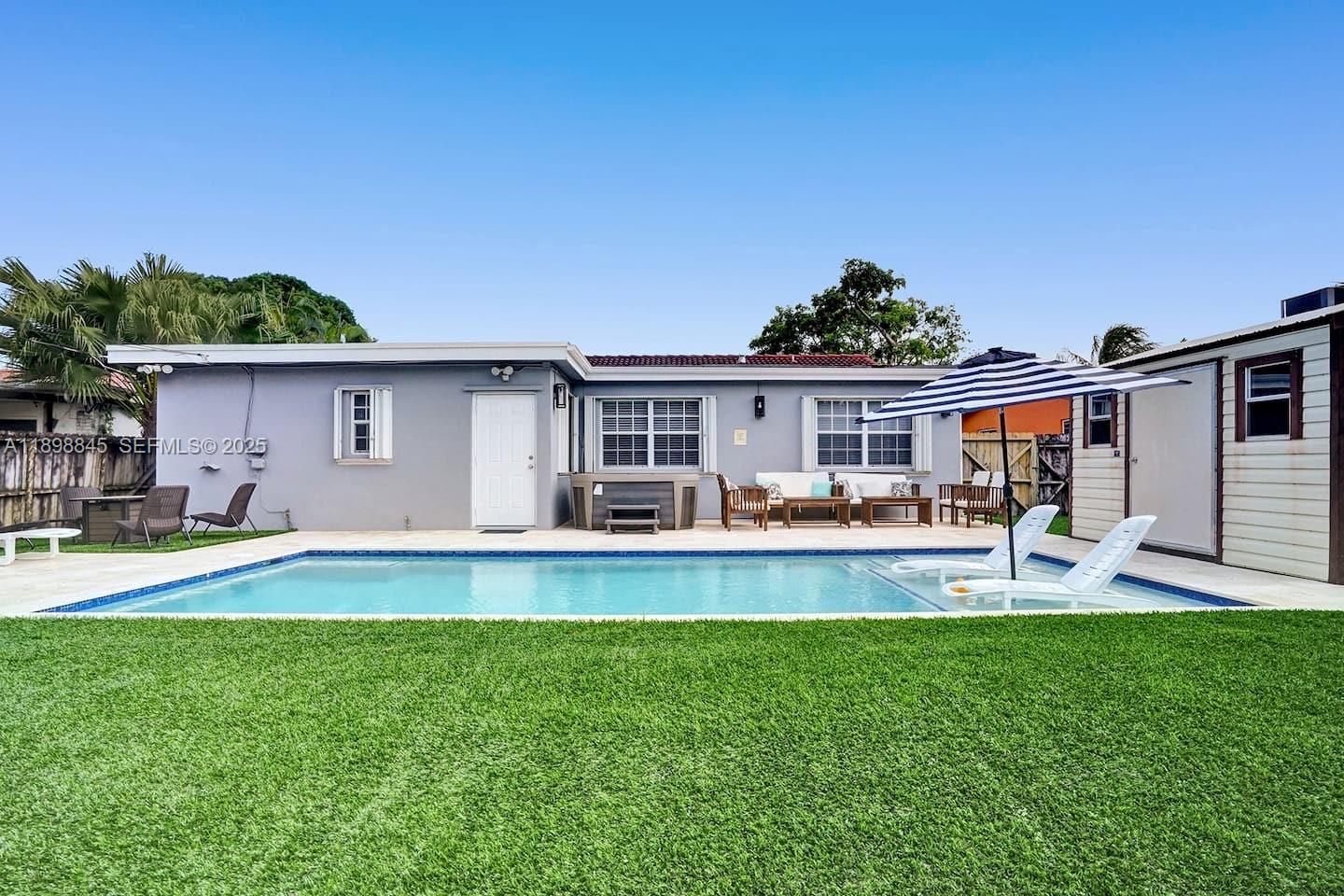 1305 Funston Street Hollywood, FL 33019 - Photo 39 of 93 a front view of a house with a yard patio and swimming pool