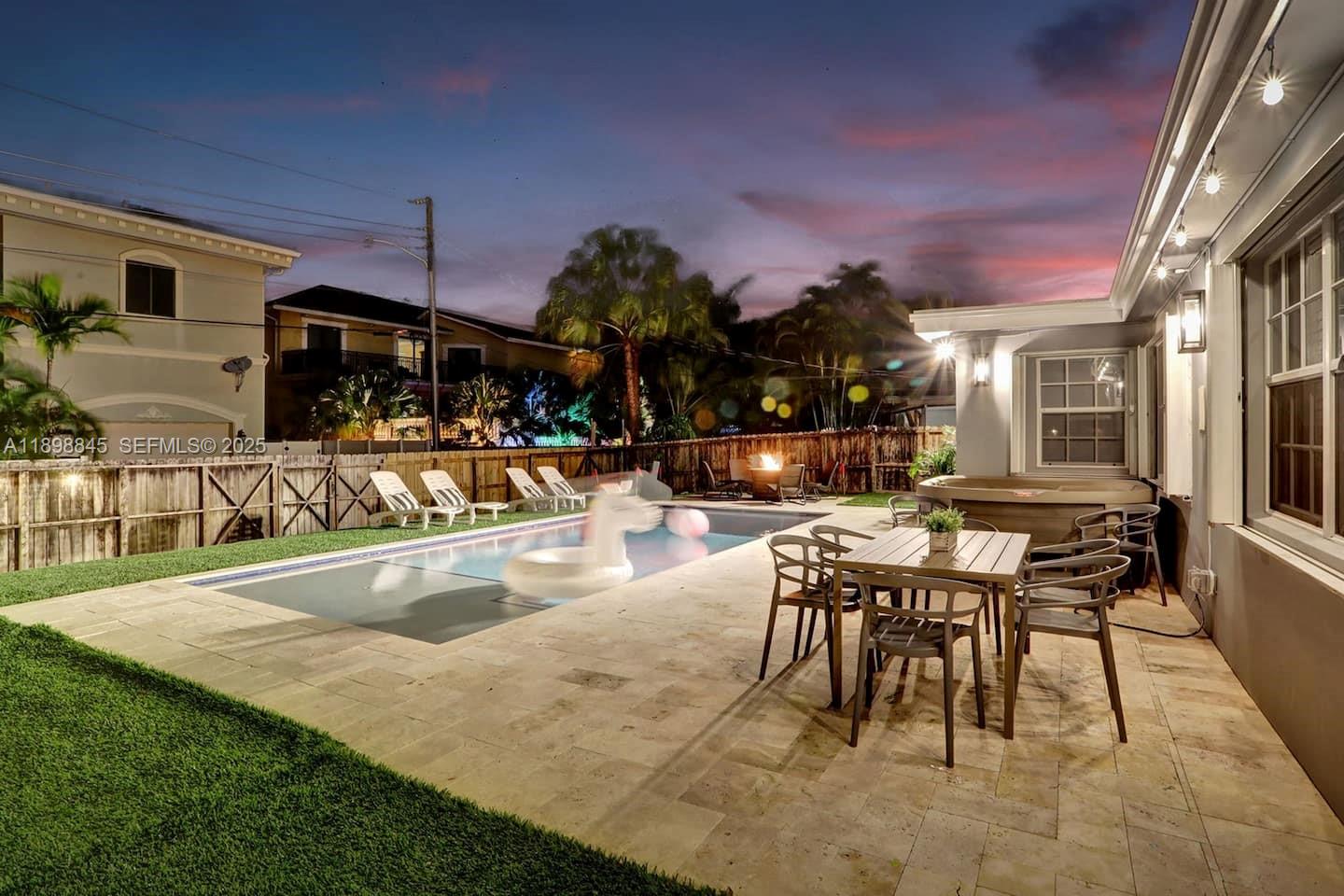 1305 Funston Street Hollywood, FL 33019 - Photo 40 of 93 a view of a swimming pool with a table and chairs