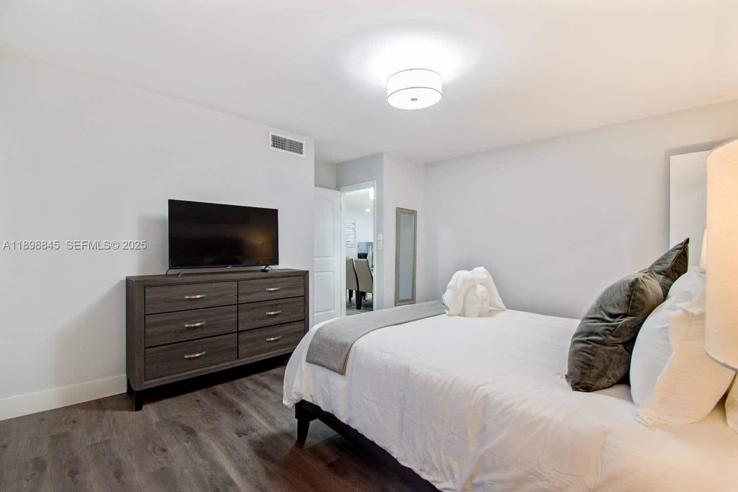 1305 Funston Street Hollywood, FL 33019 - Photo 44 of 93 a bedroom with a bed and flat screen tv