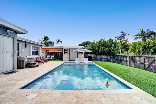 a front view of a house with a garden and yard