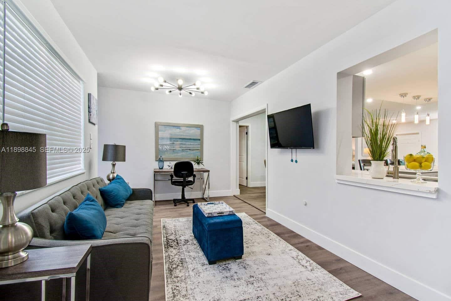 1305 Funston Street Hollywood, FL 33019 - Photo 60 of 93 a living room with furniture and a flat screen tv